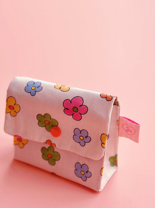 a colorful hand-drawing feel daisy pouch with contrasting snap button.