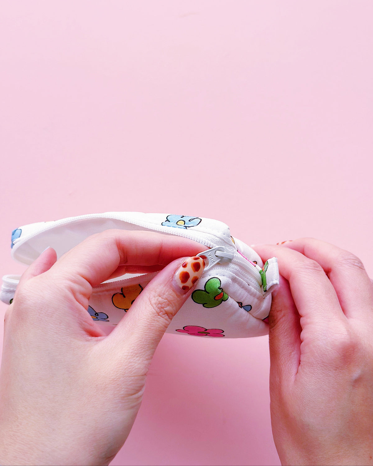 a rectangle shape zipper pouch in colorful daisy print with YKK zipper