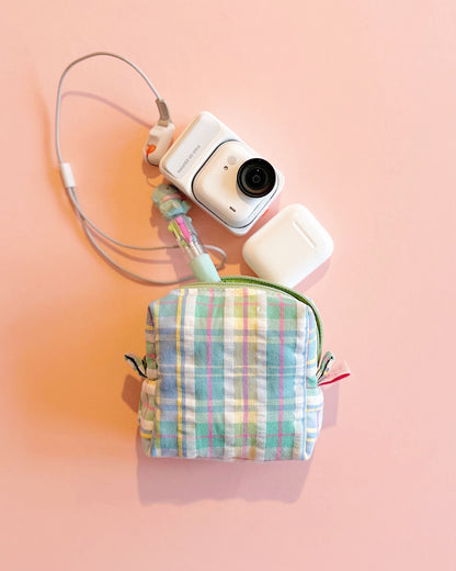 Handmade pink plaid quilted zipper pouch with cotton lining, boxy 10×10×5cm design, placed on a pastel pink background.
