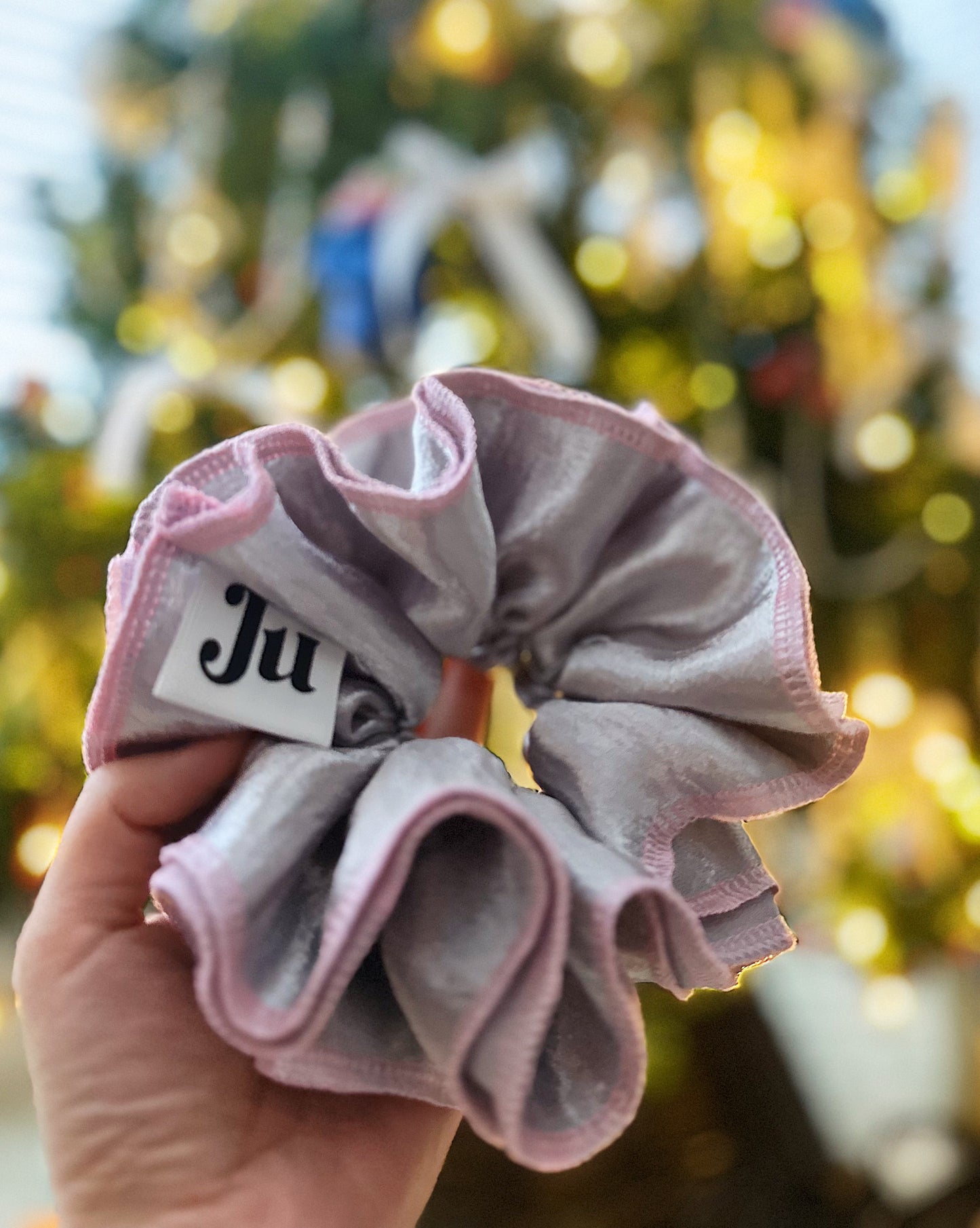 Oversized silver satin scrunchie with soft pink edges, shiny metallic hair accessory for Christmas party or festive hairstyles.