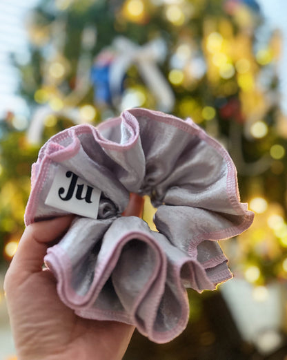 Oversized silver satin scrunchie with soft pink edges, shiny metallic hair accessory for Christmas party or festive hairstyles.