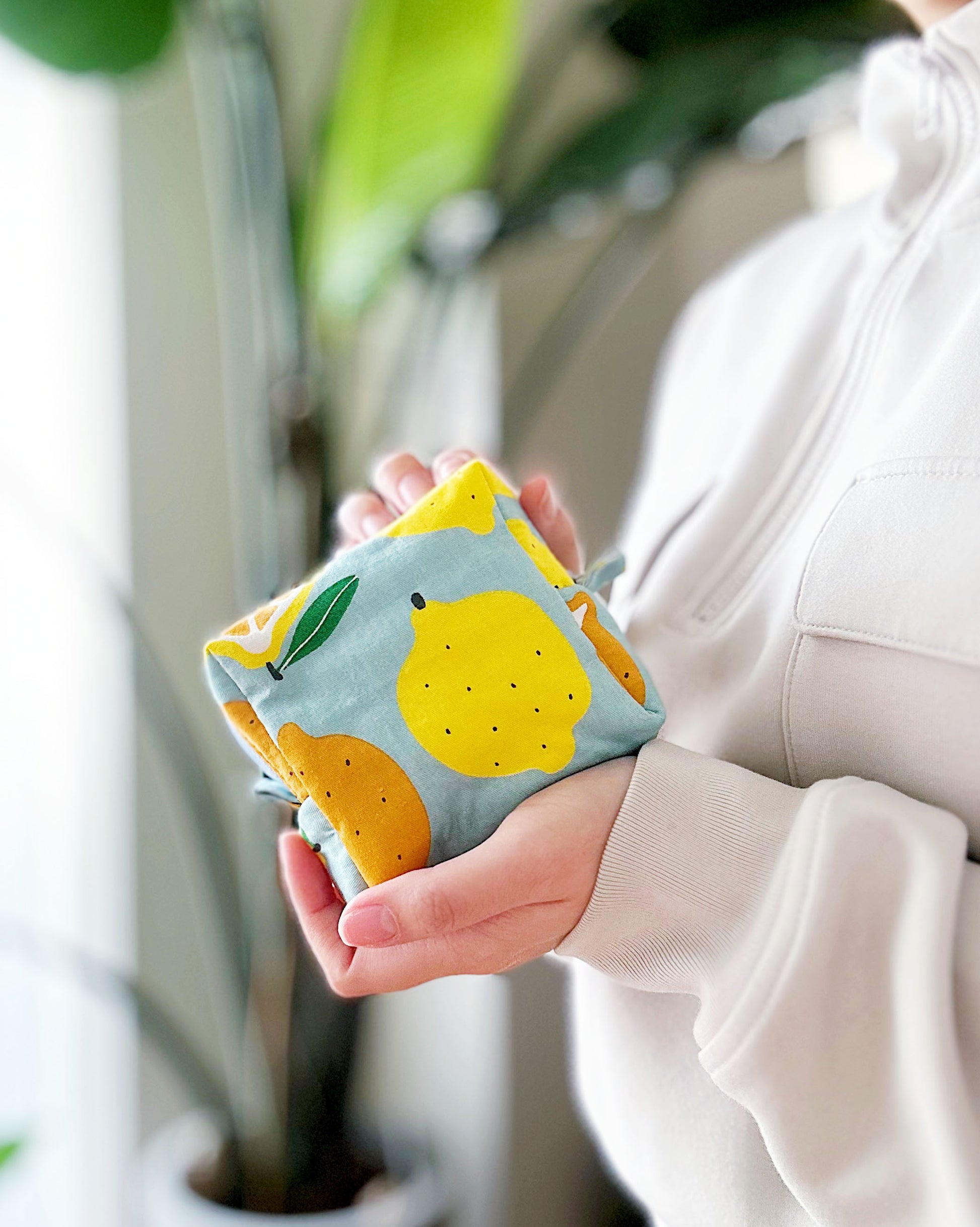 Handmade citrus print mini pouch with soft quilted padding, lemon and orange fabric bag for coins and small essentials.