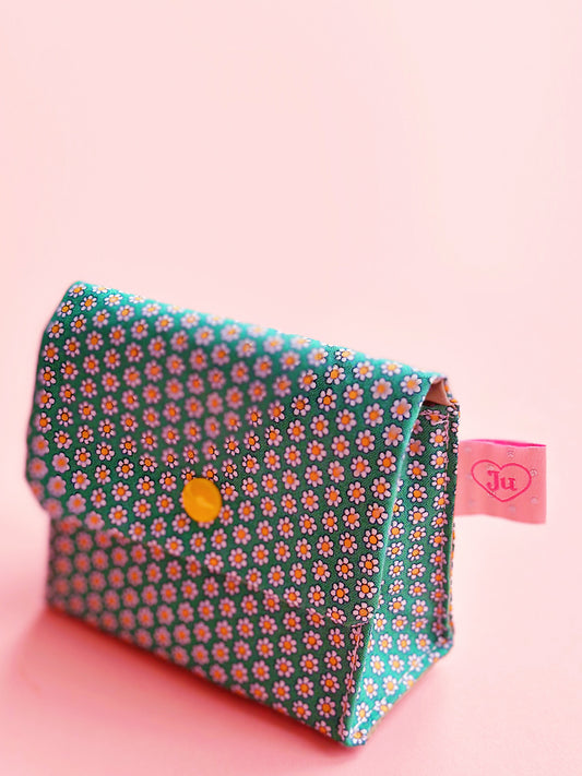 a side view of a handmade green liberty cotton fabric made snap button pouch