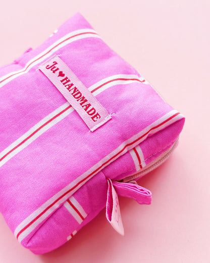 a boxy shape zipper pouch in pink striped fabric