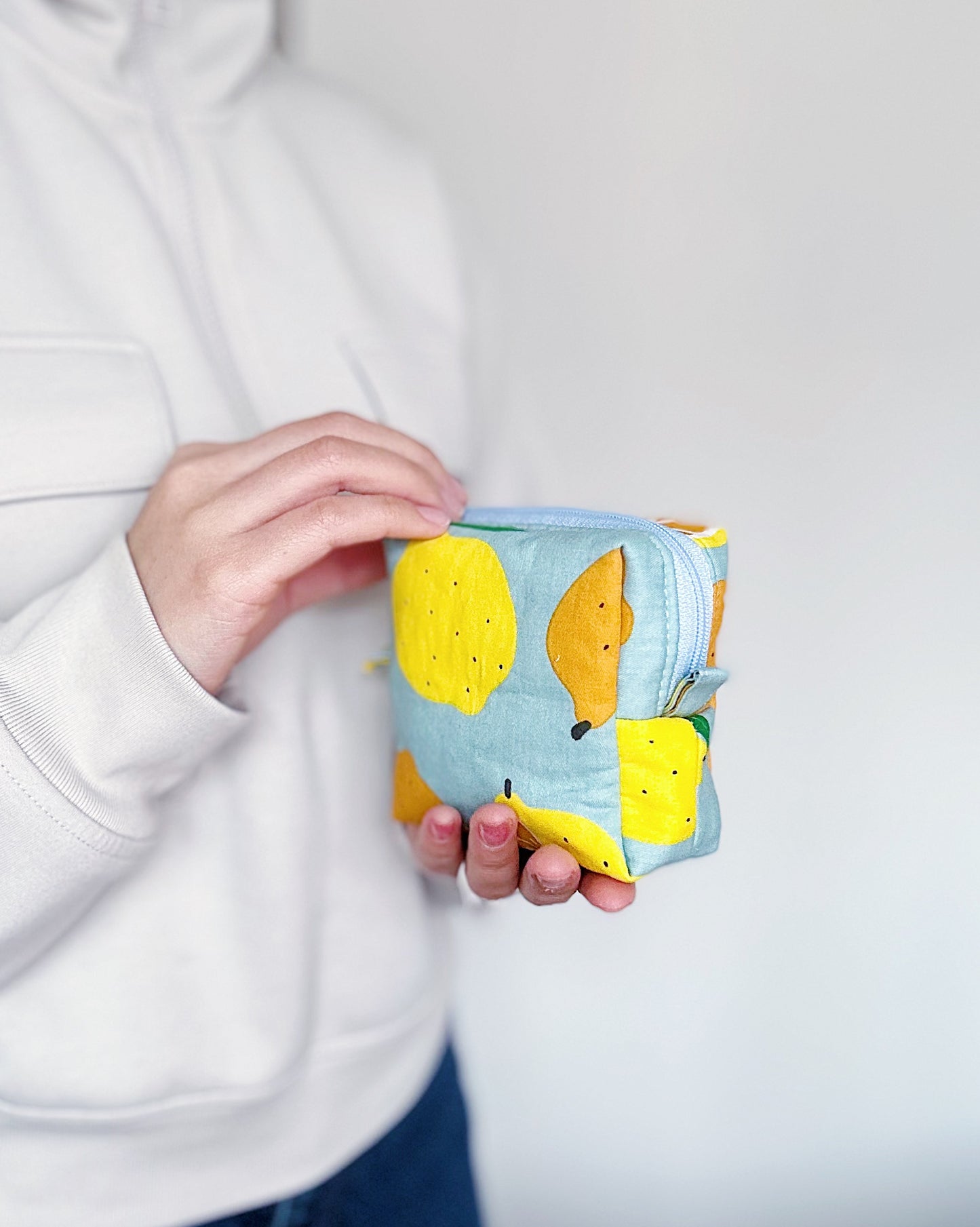 Cute citrus mini zipper pouch in pastel colors, soft quilted fruit print bag for everyday essentials.