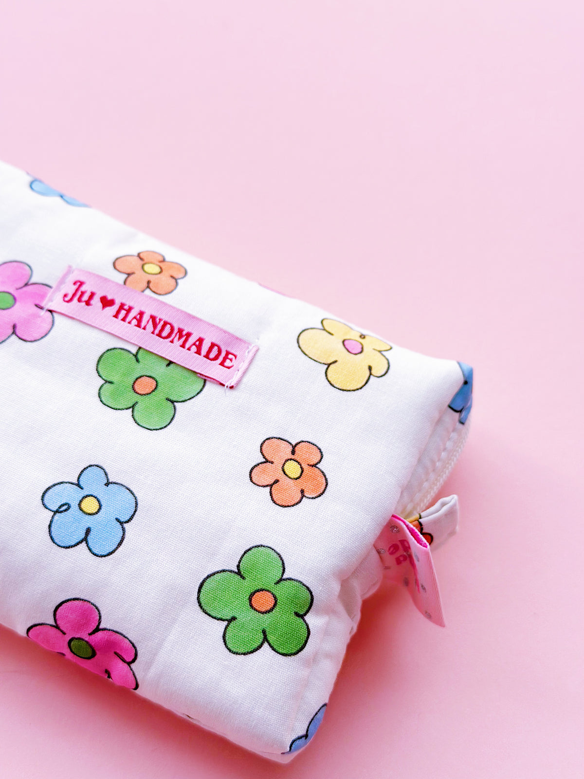 a rectangle shape zipper pouch in colorful daisy print