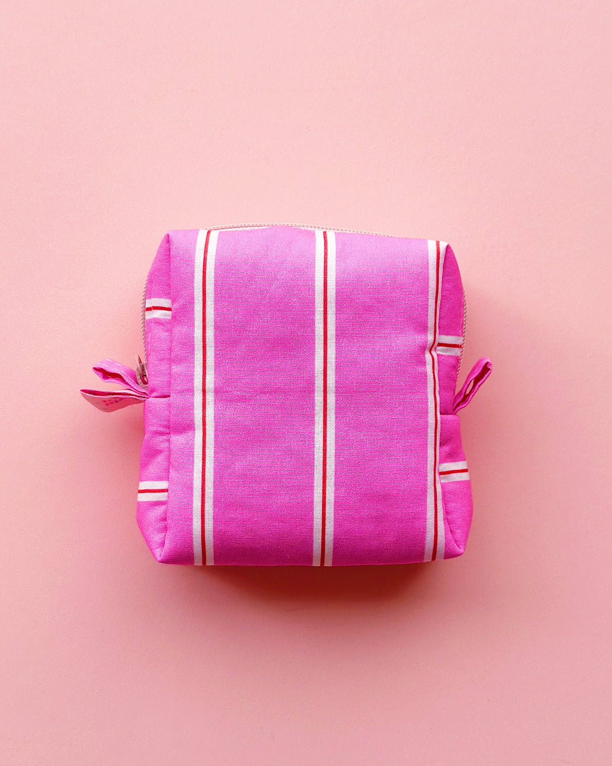 a boxy shape zipper pouch in pink striped fabric