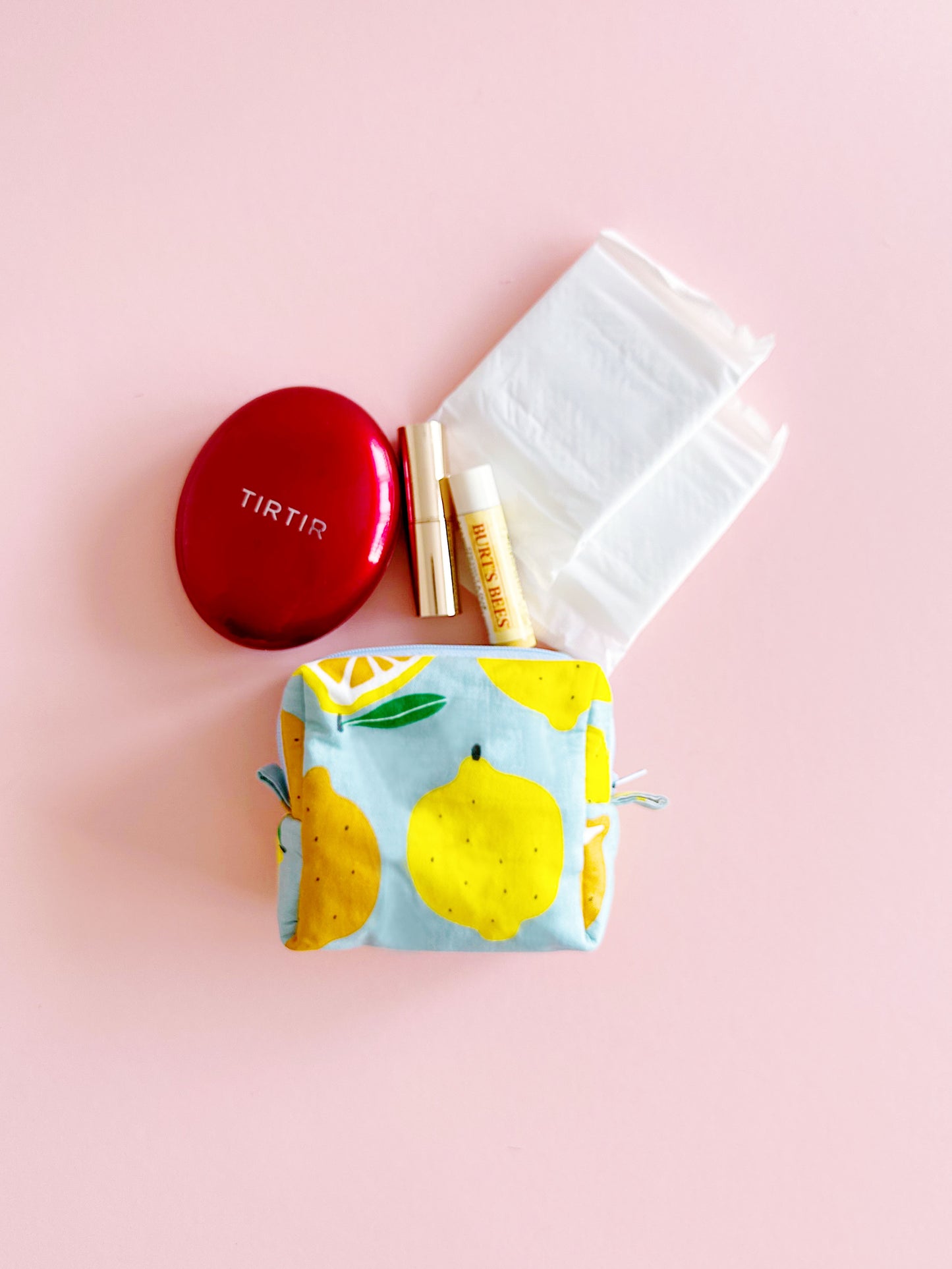 Small quilted zipper pouch with lemon and orange print on a pink background, handmade mini fabric bag, 10x10x5cm.