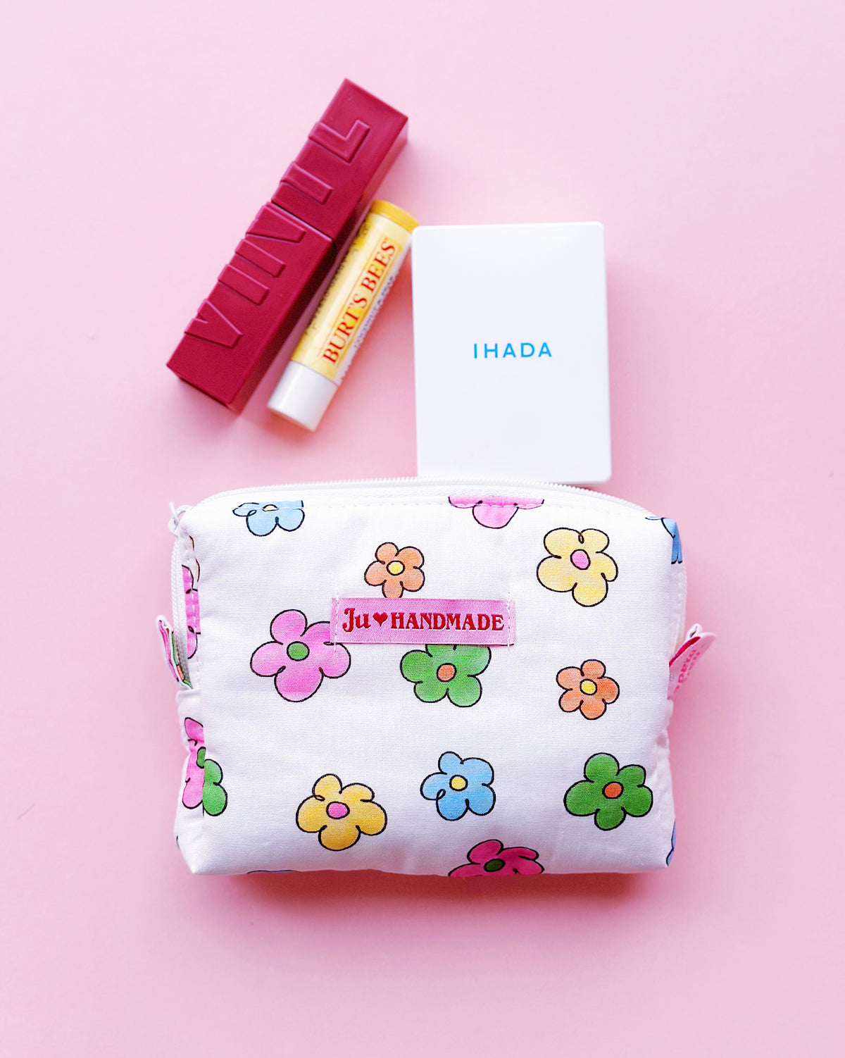 a rectangle shape zipper pouch in colorful daisy print, perfect for make up products