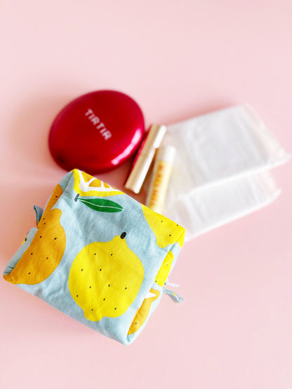 Handmade citrus print mini pouch with soft quilted padding, lemon and orange fabric bag for coins and small essentials.